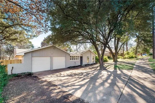 a view of a house with a yard covered in snow