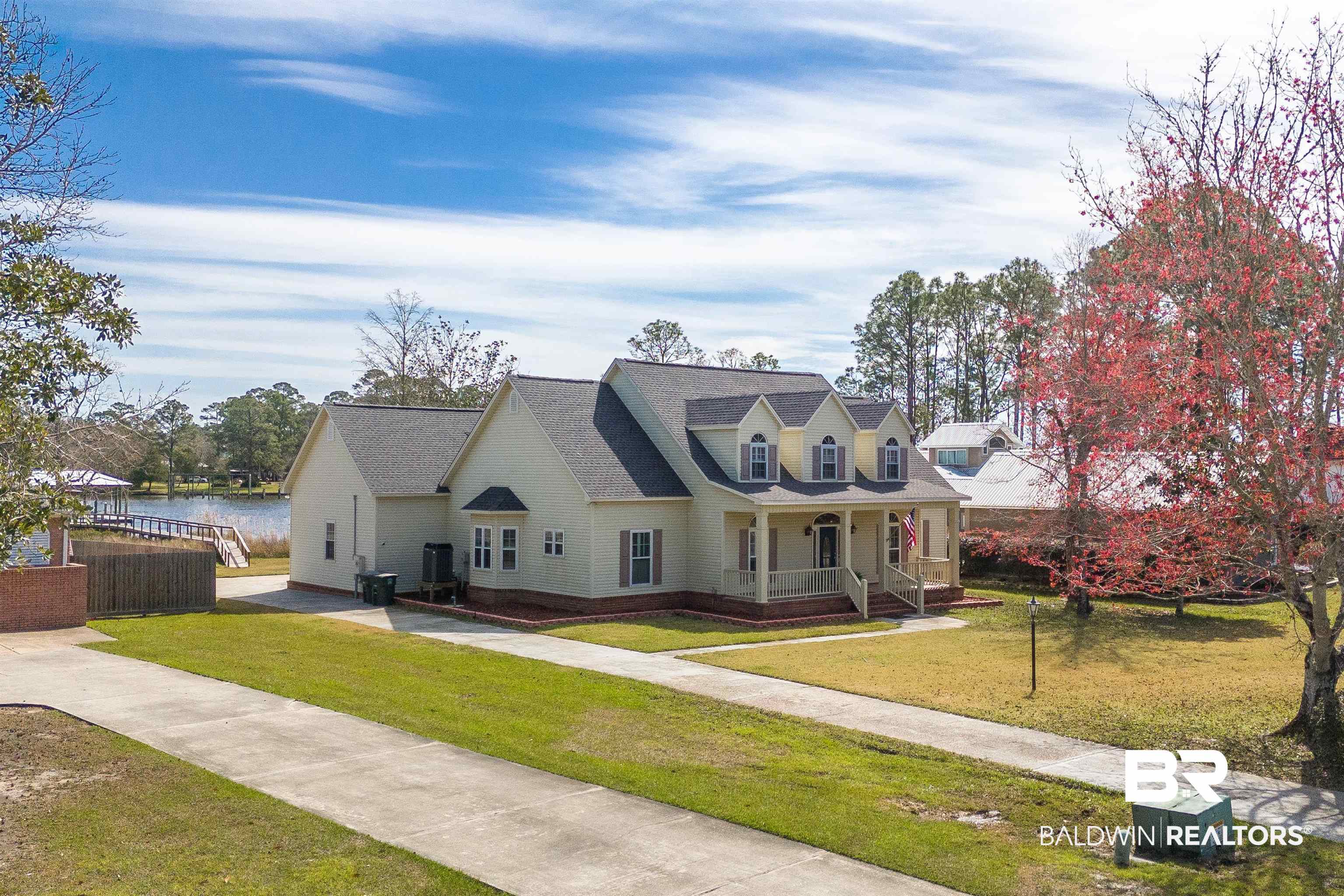 8915 Bay Point Drive Elberta, AL 36530 - Photo 3 of 74 New england style home with a front yard, covered porch, and cooling unit