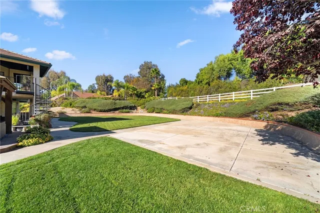 a view of a patio with couches and a table and chairs with wooden floor