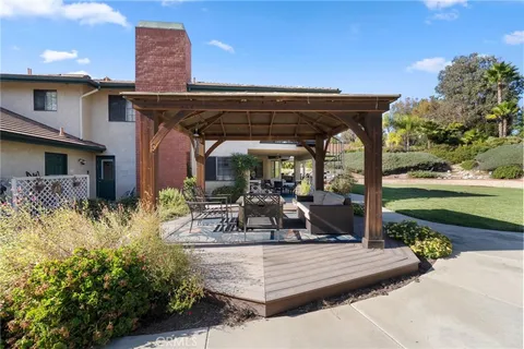 a view of a patio with couches and a table and chairs with wooden floor