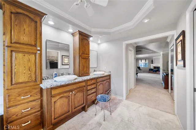 a spacious bathroom with a double vanity sink a large mirror and shower