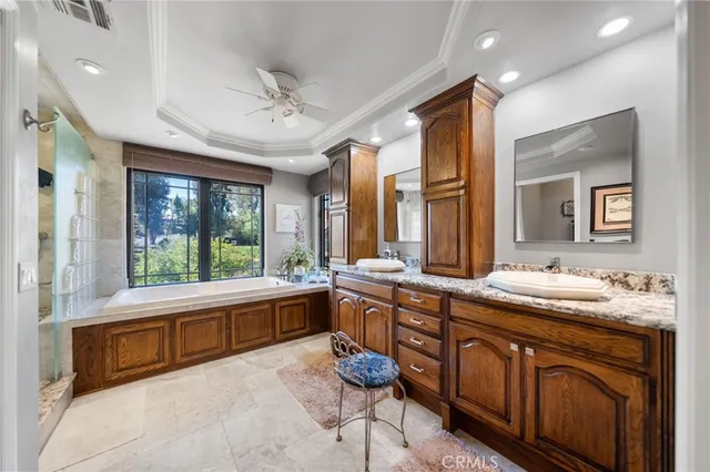 a bedroom with a bed couch and windows