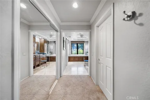 a bedroom with a bed couch and windows