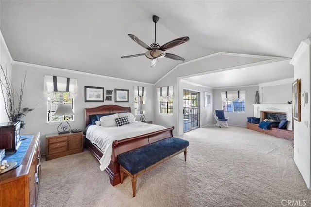 a view of a livingroom with furniture fire place wooden floor and fireplace
