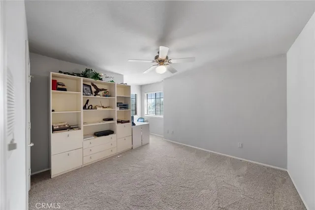 a kitchen with stainless steel appliances kitchen island granite countertop a refrigerator a stove top oven and a sink with granite countertops