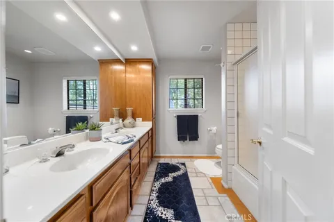 a kitchen with stainless steel appliances kitchen island granite countertop a refrigerator a stove top oven and a sink with granite countertops