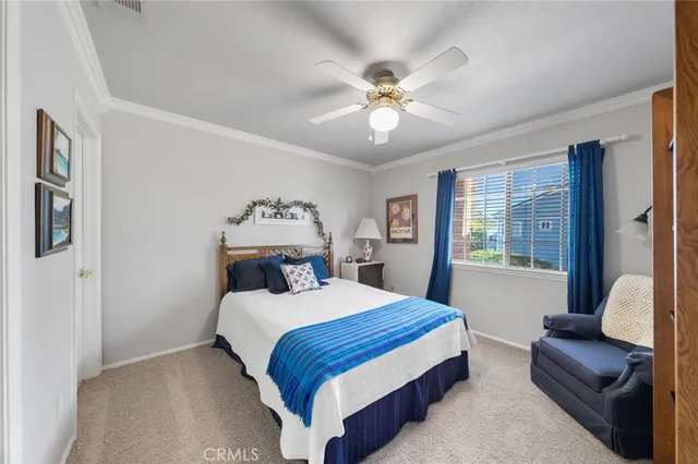 a dining room with furniture and a floor to ceiling window