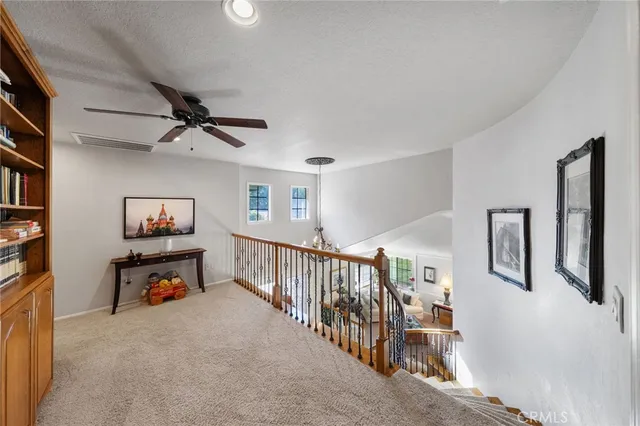 a living room with furniture a fireplace and a large window