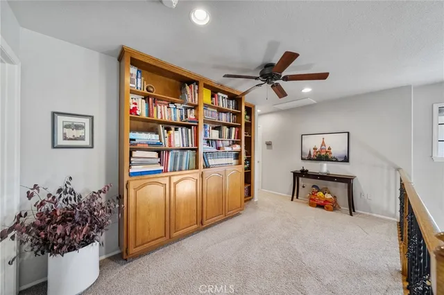 a living room with furniture fireplace and a large window