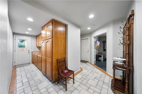 a living room with furniture a fireplace and a potted plant