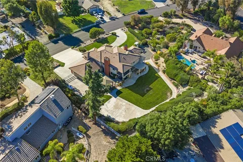 an aerial view of a house with a garden and swimming pool