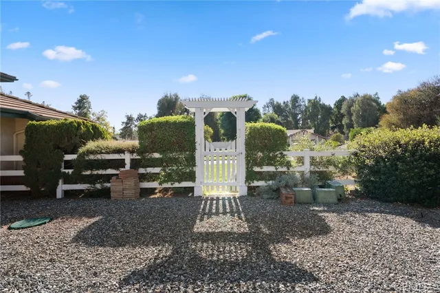 a kitchen with stainless steel appliances granite countertop a sink and wooden cabinets