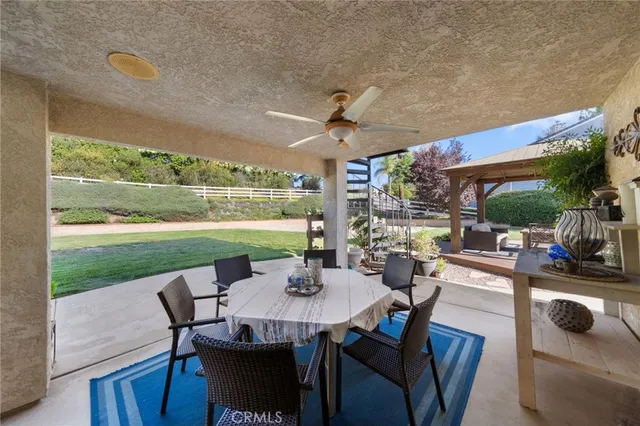 a view of a patio with a table and chairs