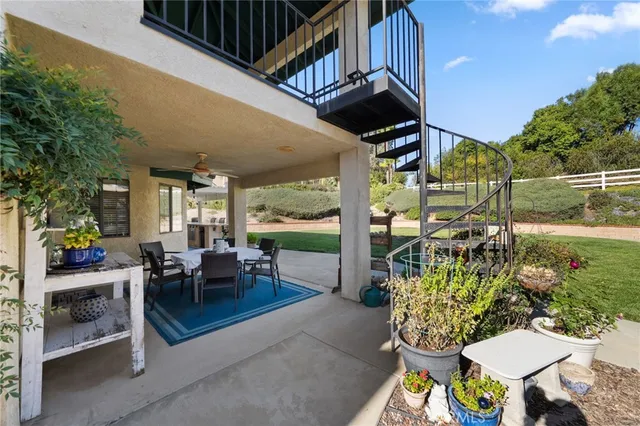 a view of a porch with furniture and garden
