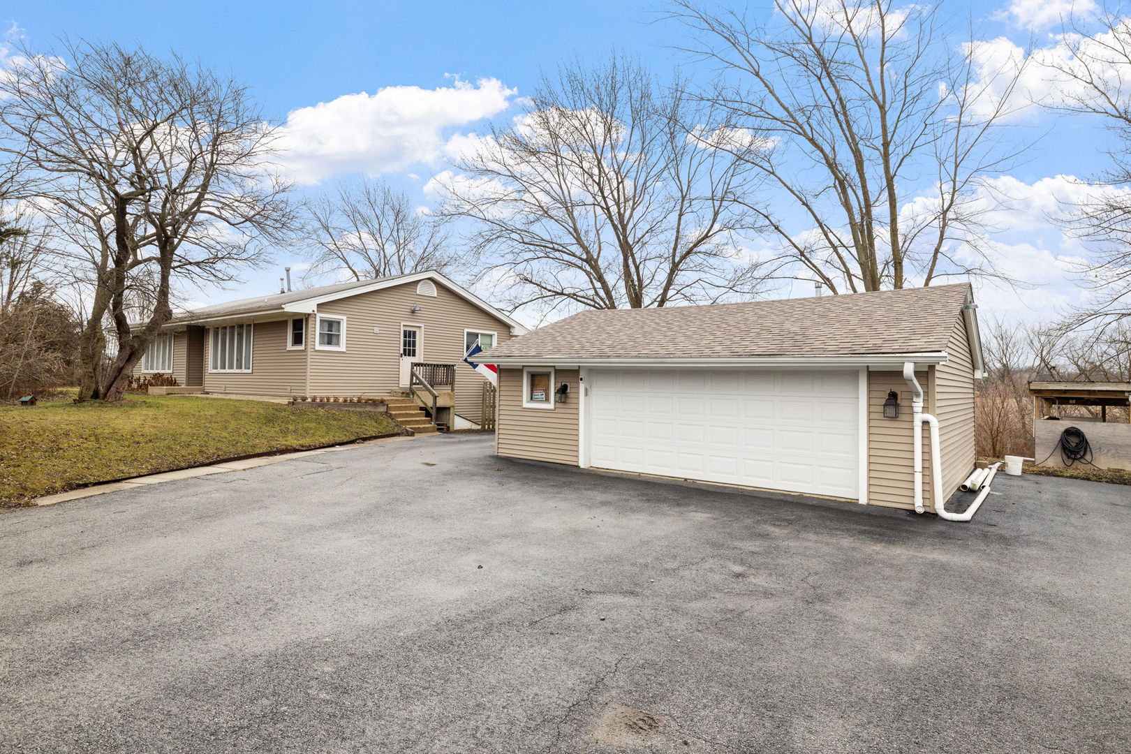 2315 East Steger Road Crete, IL 60417 - Photo 2 of 24 a view of a house with a large tree and a yard