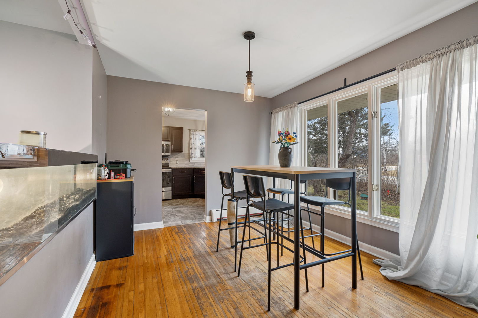2315 East Steger Road Crete, IL 60417 - Photo 4 of 24 a view of a dining room with furniture window and wooden floor
