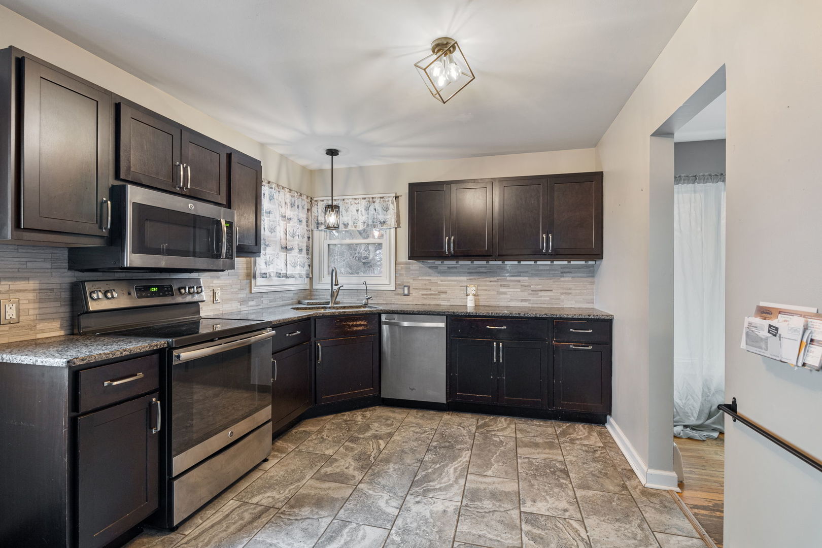 2315 East Steger Road Crete, IL 60417 - Photo 5 of 24 a kitchen with stainless steel appliances granite countertop a stove microwave and refrigerator