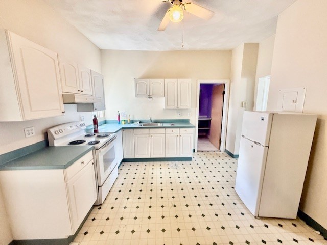 a kitchen with a sink a refrigerator a stove a washer and dryer