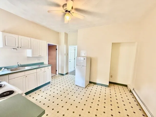 a kitchen with a refrigerator and a sink