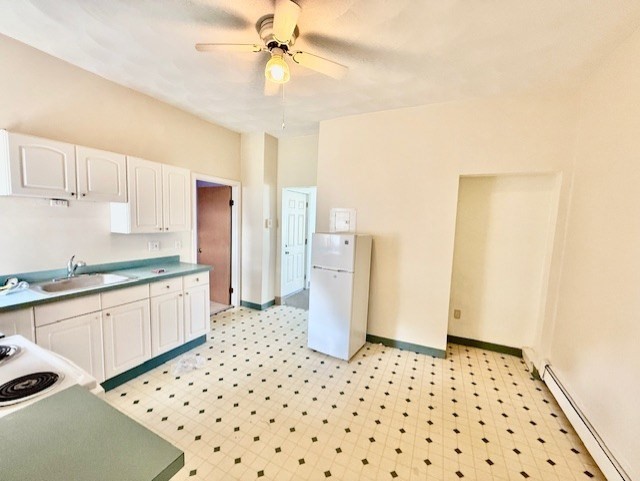 540 Cambridge Street, Unit 3 Cambridge, MA 02141 - Photo 2 of 13 a kitchen with a refrigerator and a sink