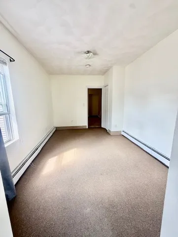 an empty room with a empty space and windows