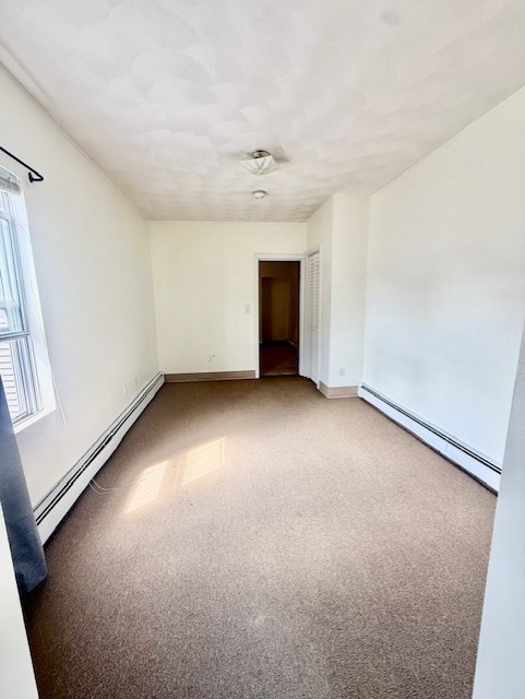 540 Cambridge Street, Unit 3 Cambridge, MA 02141 - Photo 10 of 13 an empty room with a empty space and windows