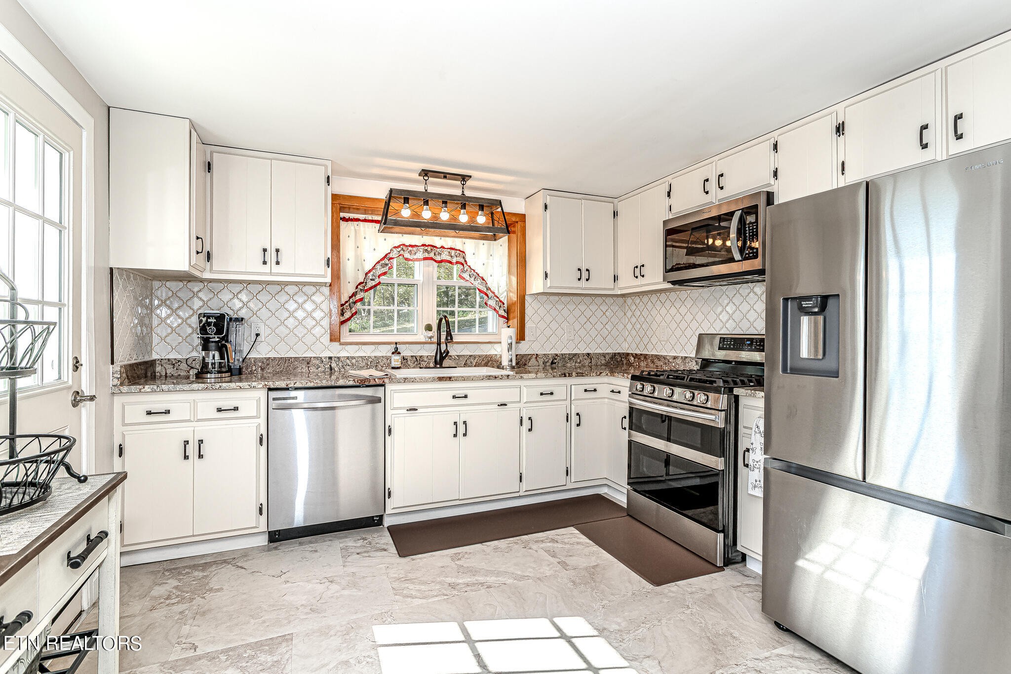 91 Orchard Road Norris, TN 37828 - Photo 12 of 54 a kitchen with granite countertop a refrigerator stove top oven and sink