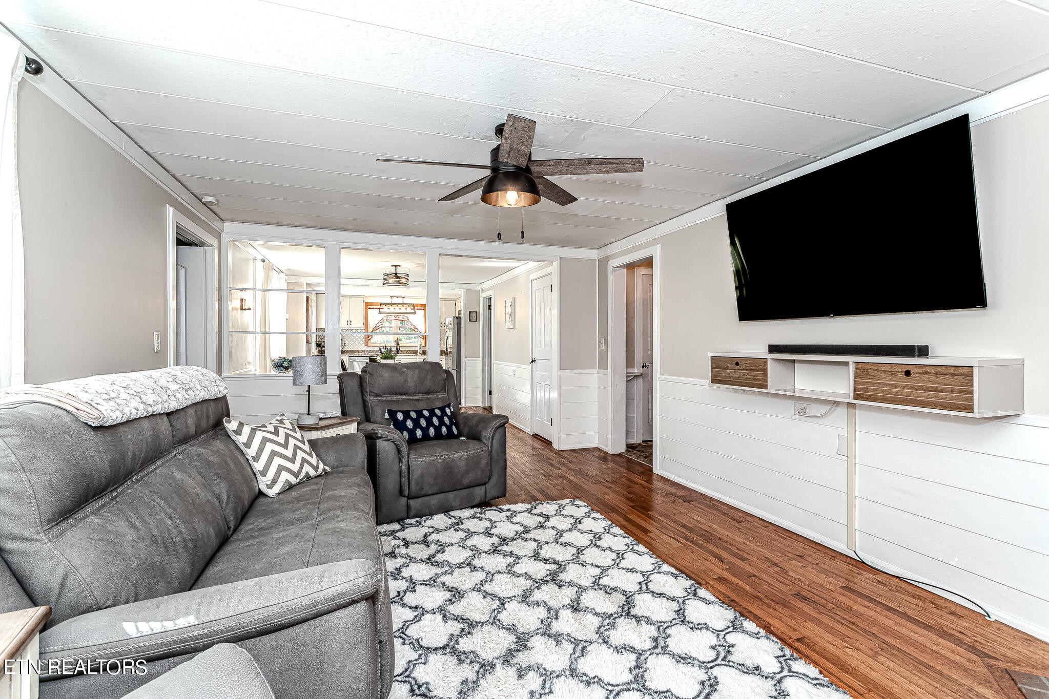 91 Orchard Road Norris, TN 37828 - Photo 22 of 54 a living room with furniture and a flat screen tv