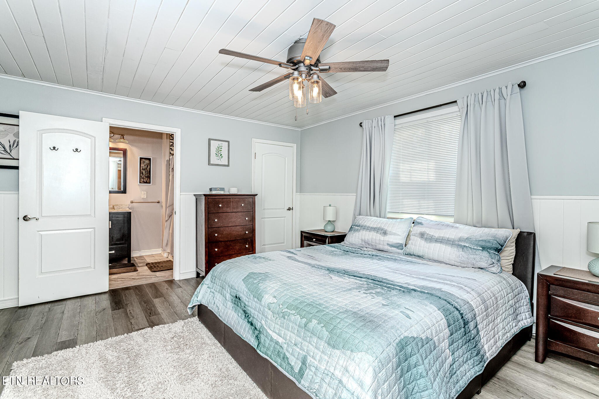 91 Orchard Road Norris, TN 37828 - Photo 24 of 54 a bedroom with a large bed and a chandelier