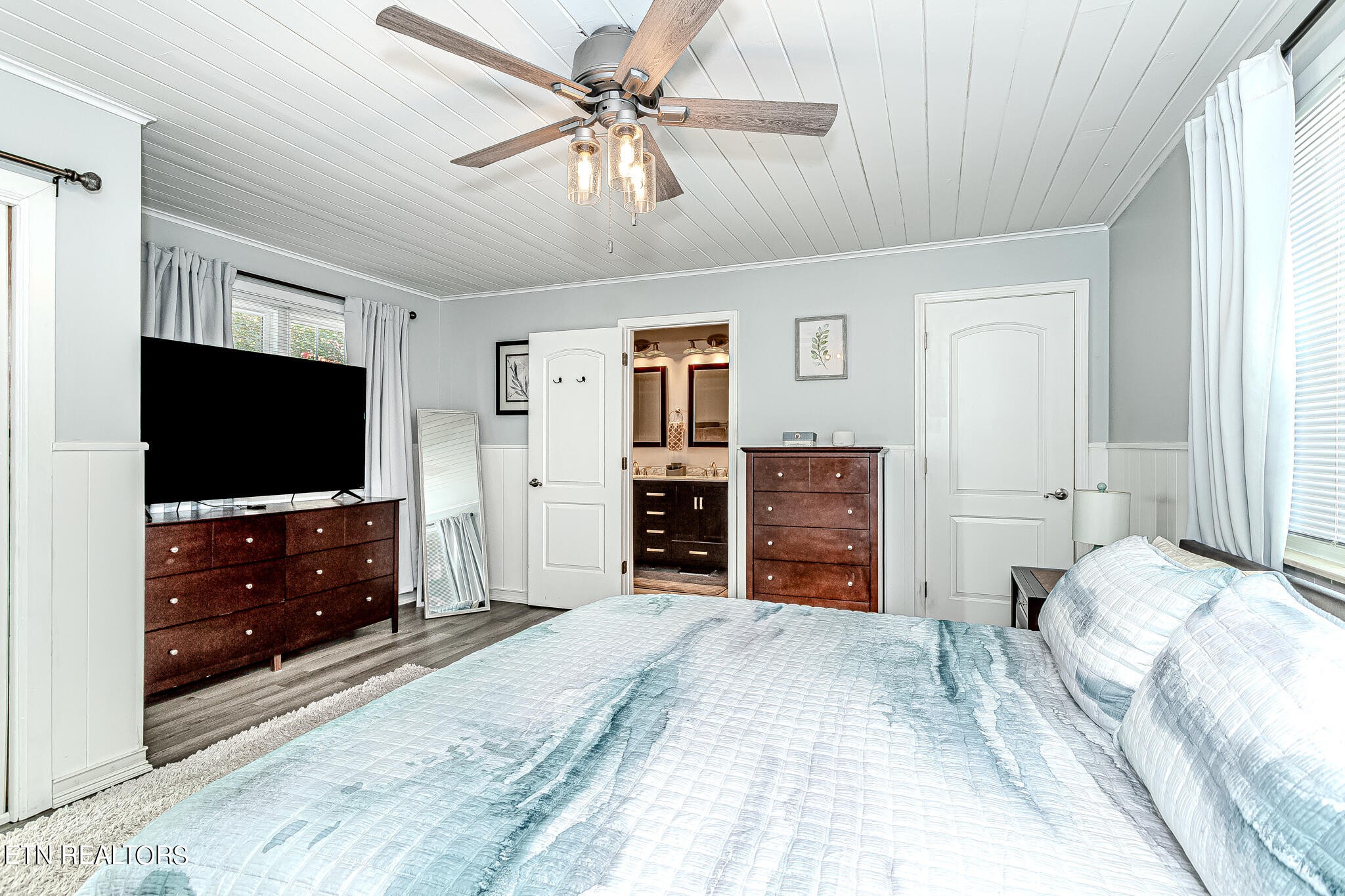 91 Orchard Road Norris, TN 37828 - Photo 26 of 54 a bedroom with a bed and a flat tv screen on dresser