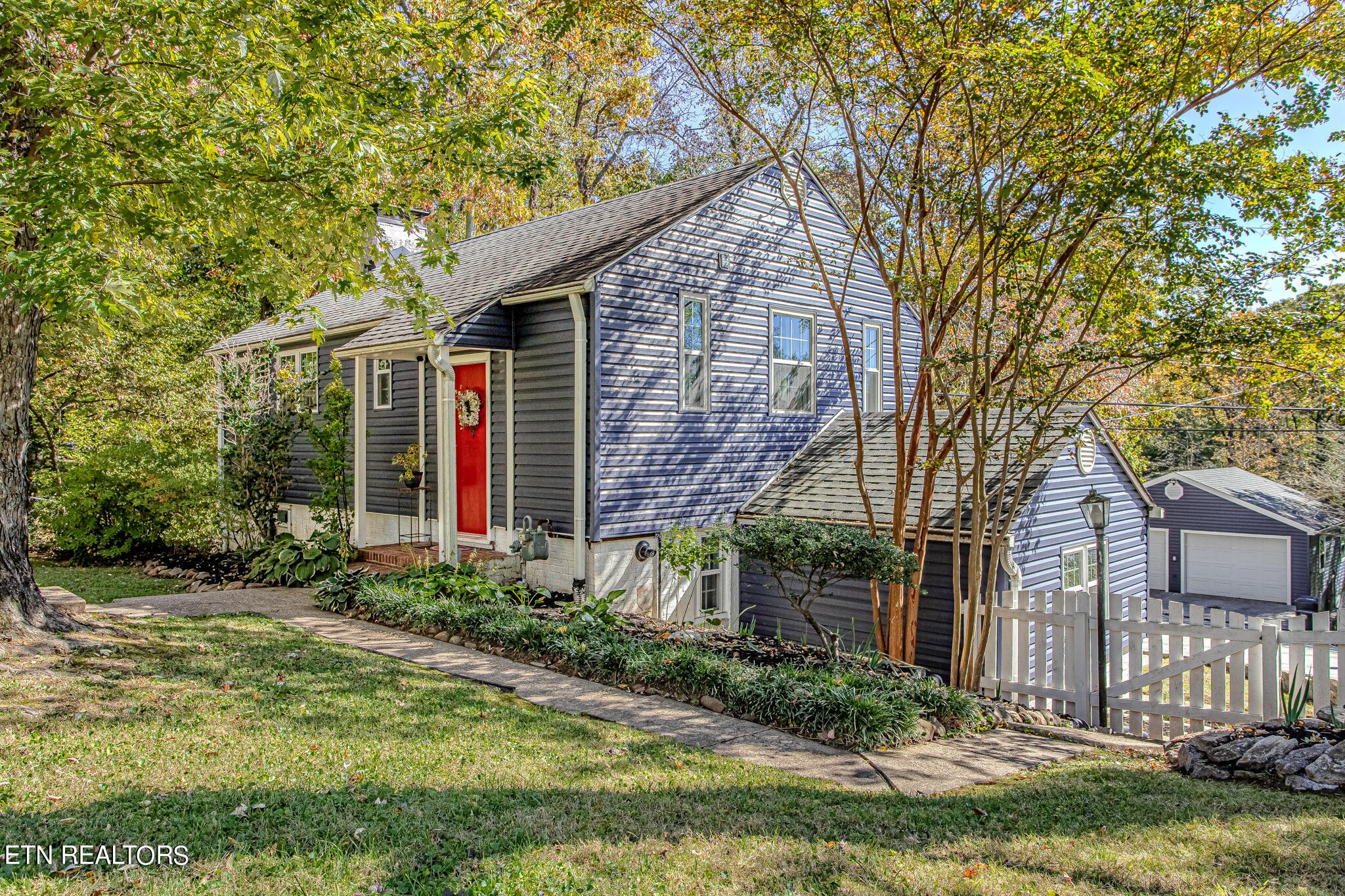 91 Orchard Road Norris, TN 37828 - Photo 3 of 54 a front view of a house with garden