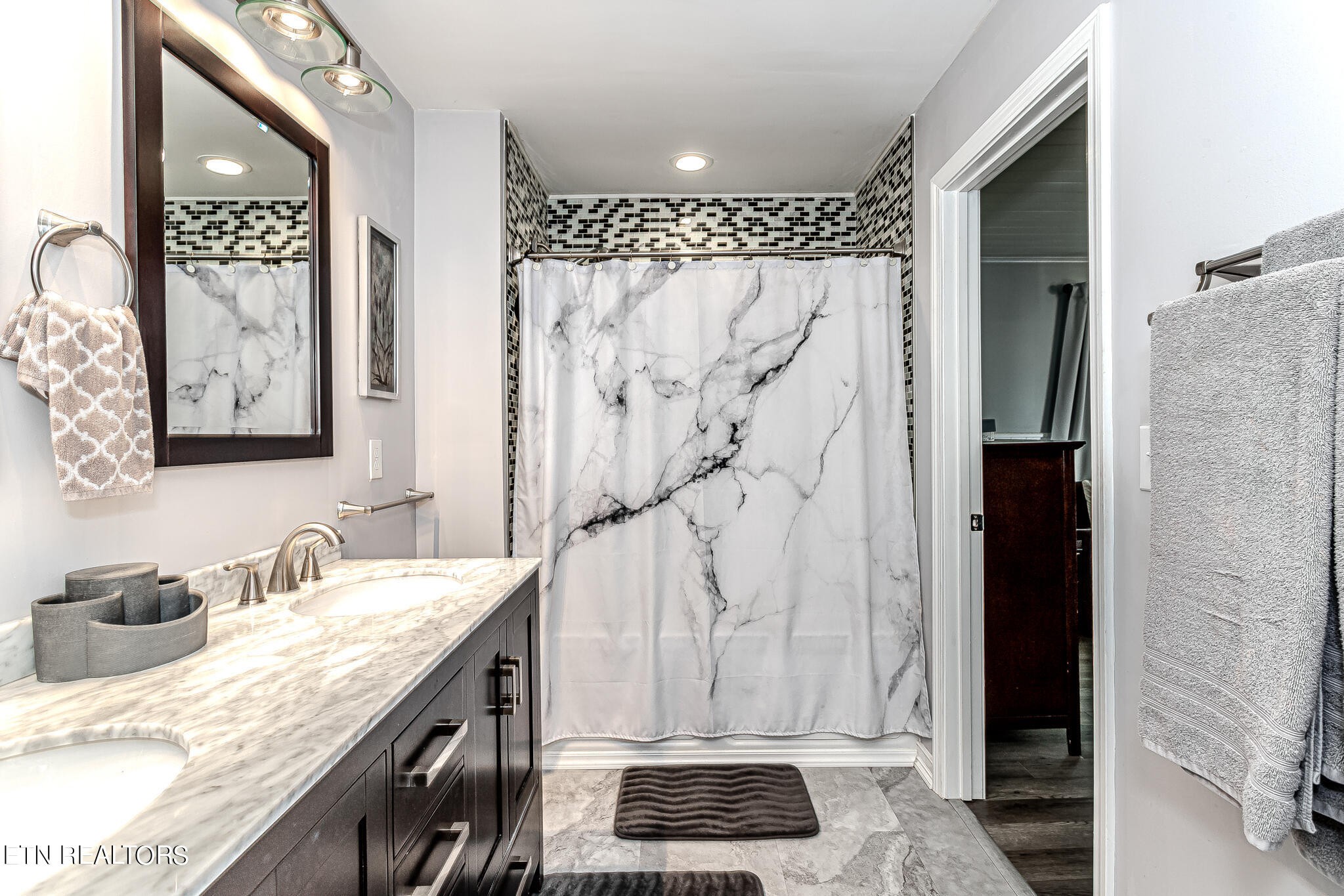 91 Orchard Road Norris, TN 37828 - Photo 31 of 54 a bathroom with a granite countertop sink a mirror and shower