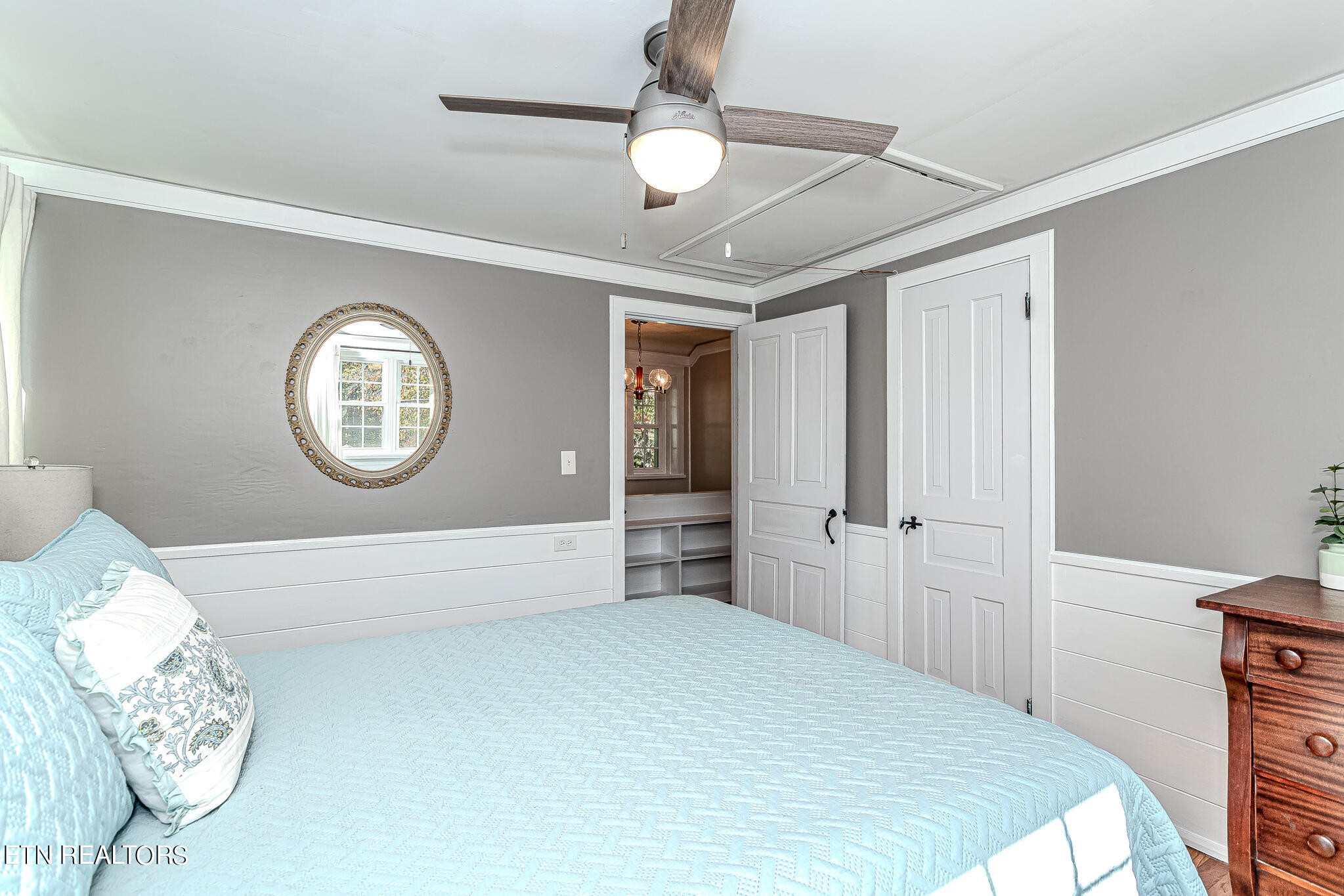 91 Orchard Road Norris, TN 37828 - Photo 34 of 54 a spacious bedroom with a bed and a chandelier