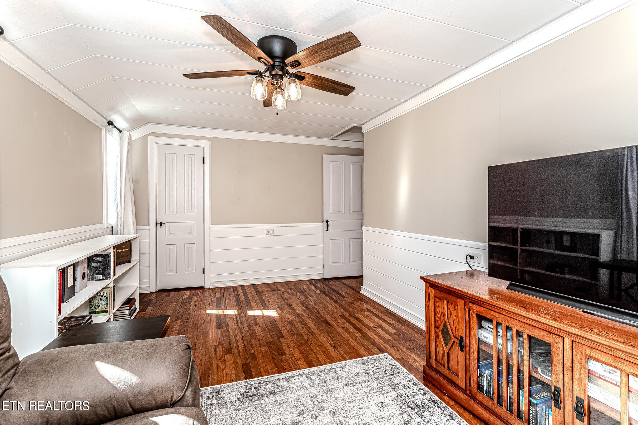 91 Orchard Road Norris, TN 37828 - Photo 40 of 54 a living room with furniture and a flat screen tv
