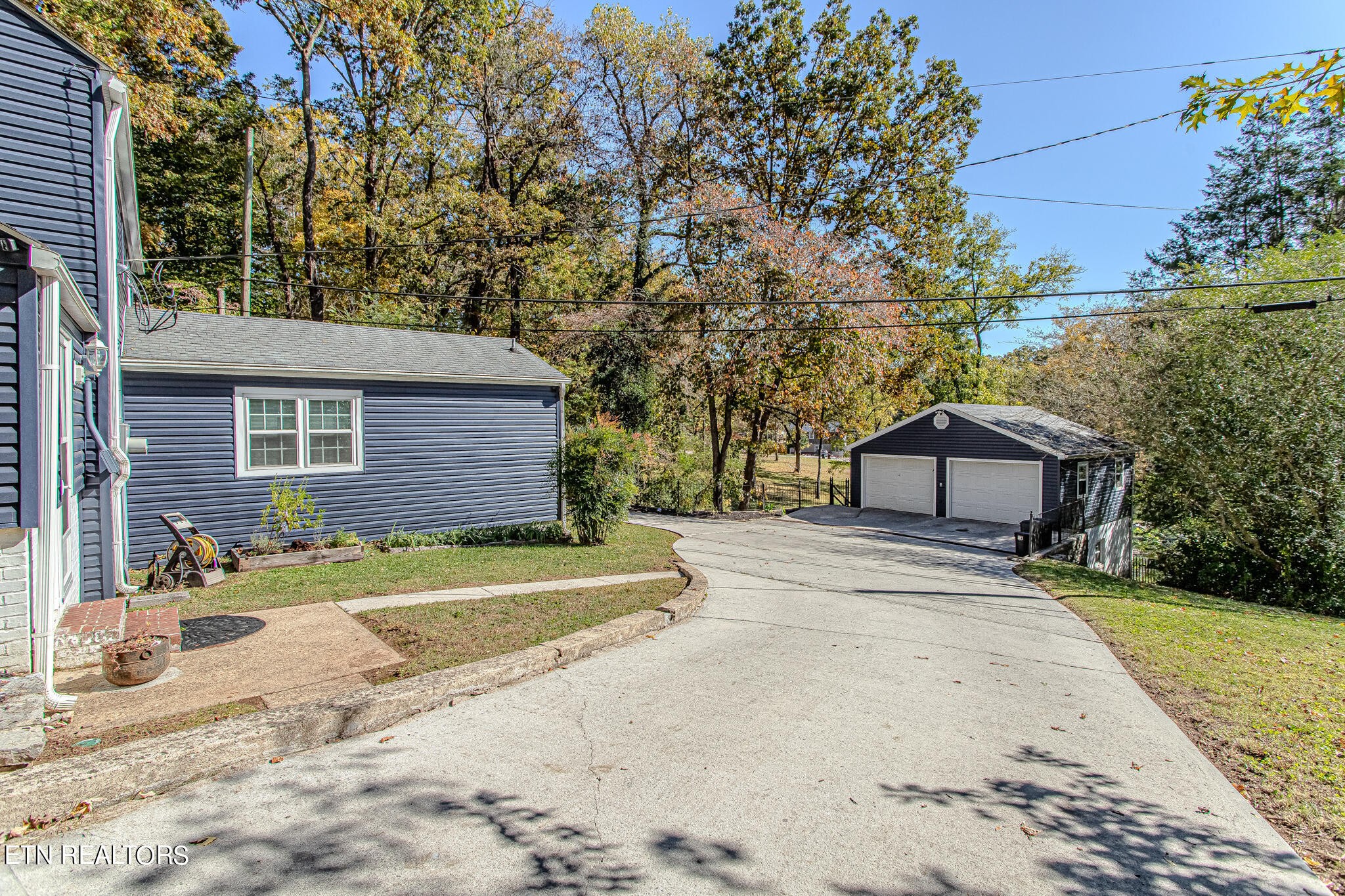 91 Orchard Road Norris, TN 37828 - Photo 4 of 54 a front view of a house with a yard and trees