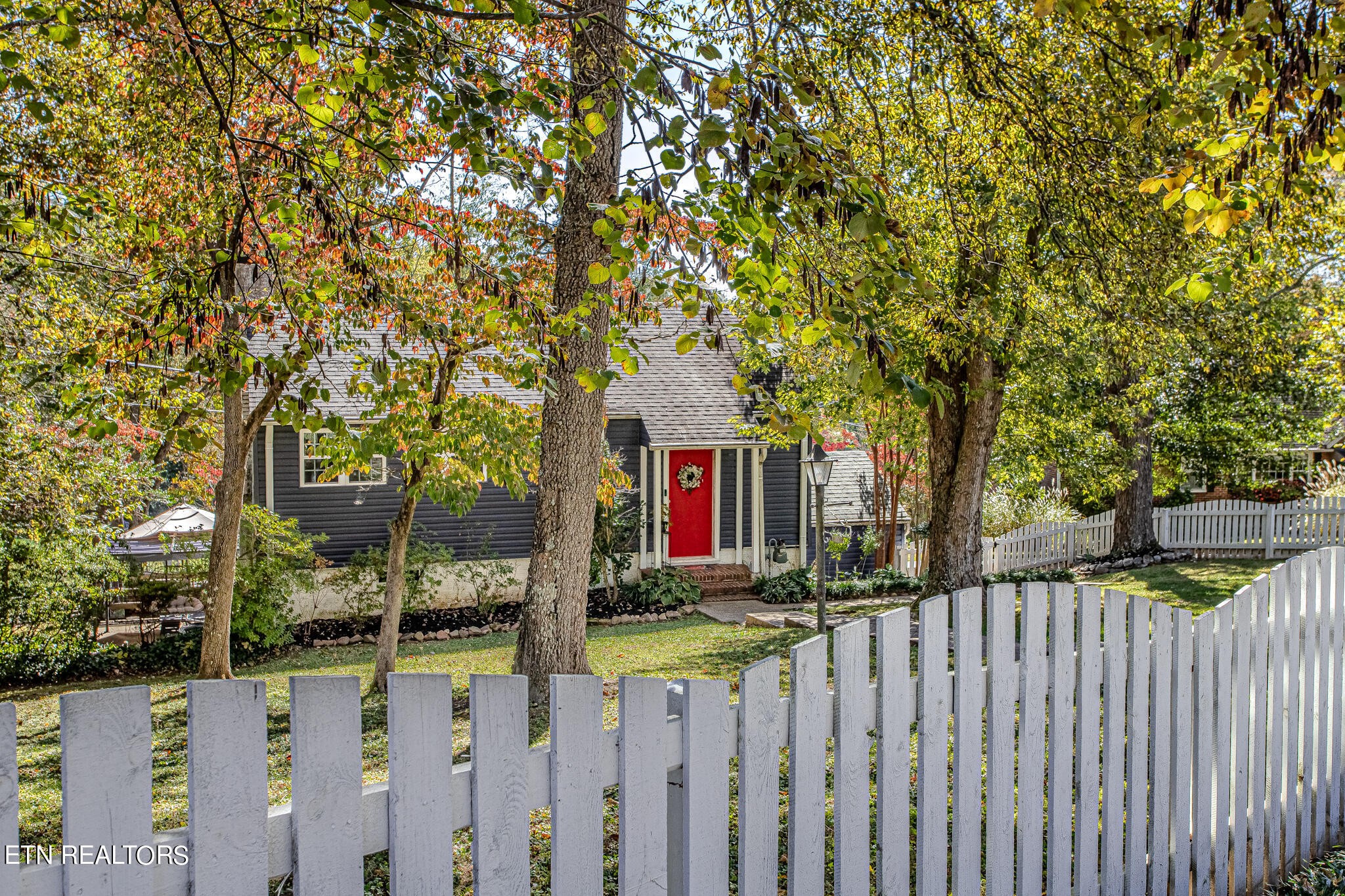 91 Orchard Road Norris, TN 37828 - Photo 44 of 54 a front view of a house with wooden fence