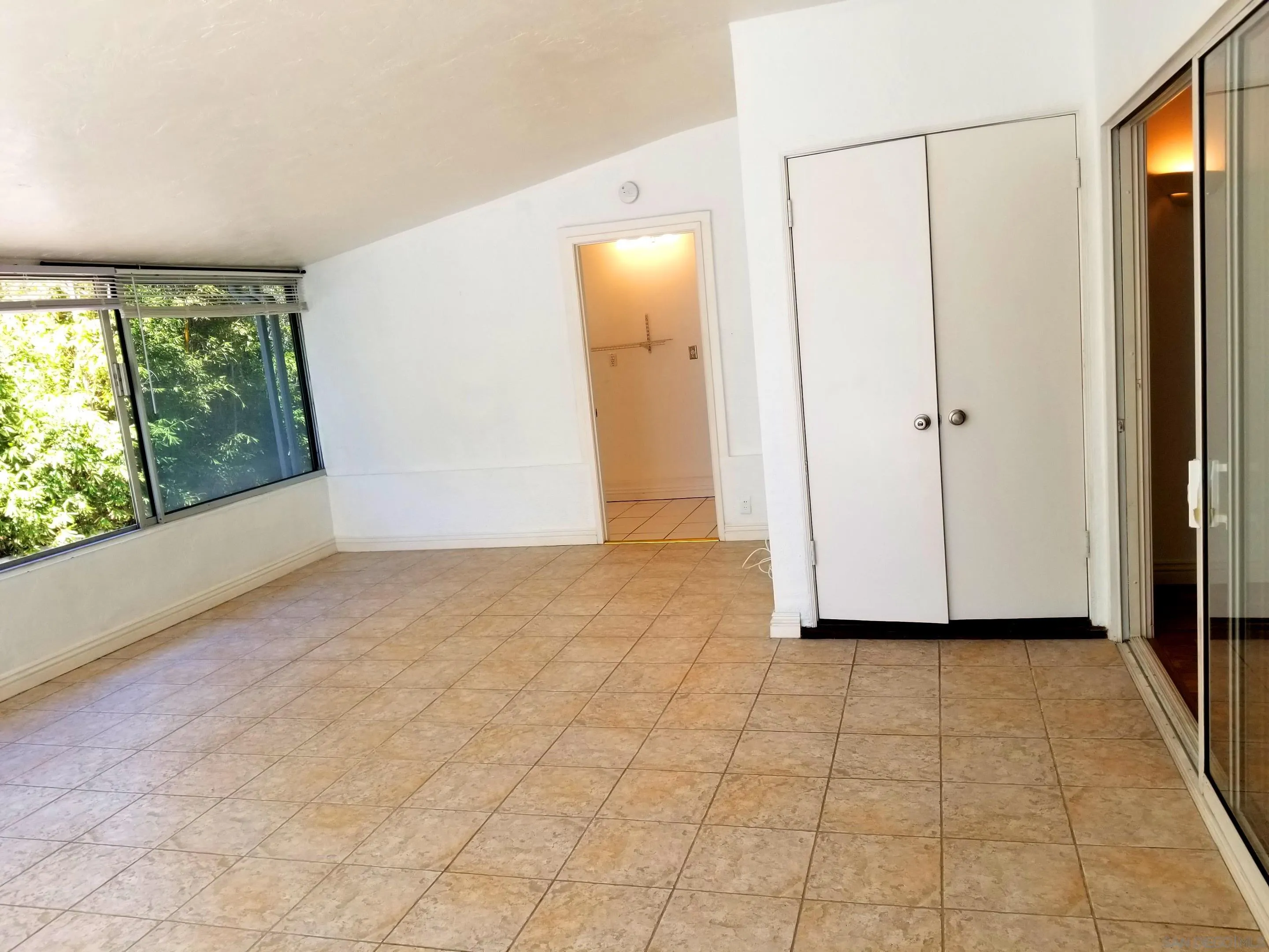 2358 Torrey Pines Road, Unit 19 La Jolla, CA 92037 - Photo 18 of 28 an empty room with windows and closet