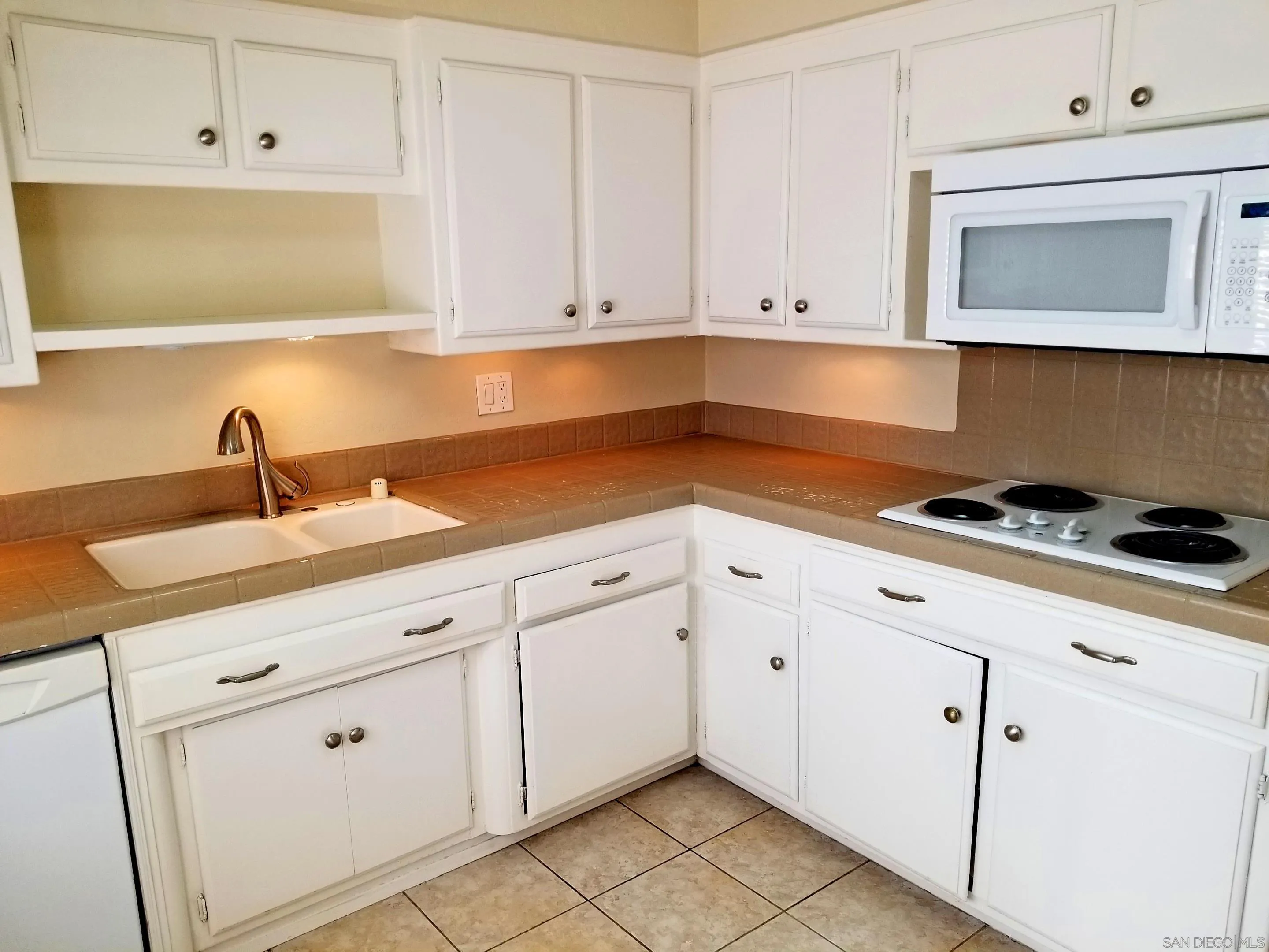 2358 Torrey Pines Road, Unit 19 La Jolla, CA 92037 - Photo 3 of 28 a kitchen with white cabinets and white appliances