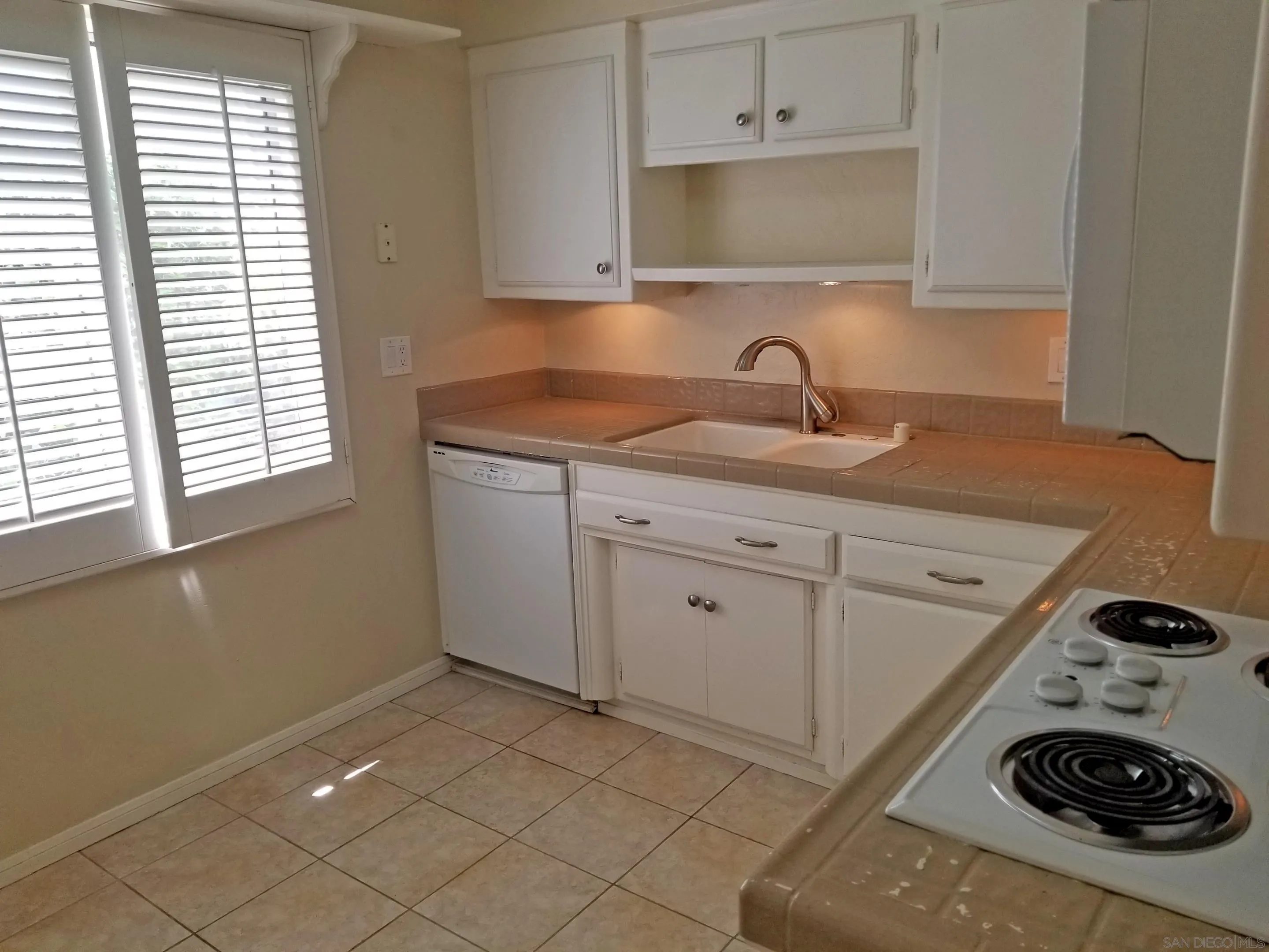 2358 Torrey Pines Road, Unit 19 La Jolla, CA 92037 - Photo 5 of 28 a kitchen with a sink and a stove top oven
