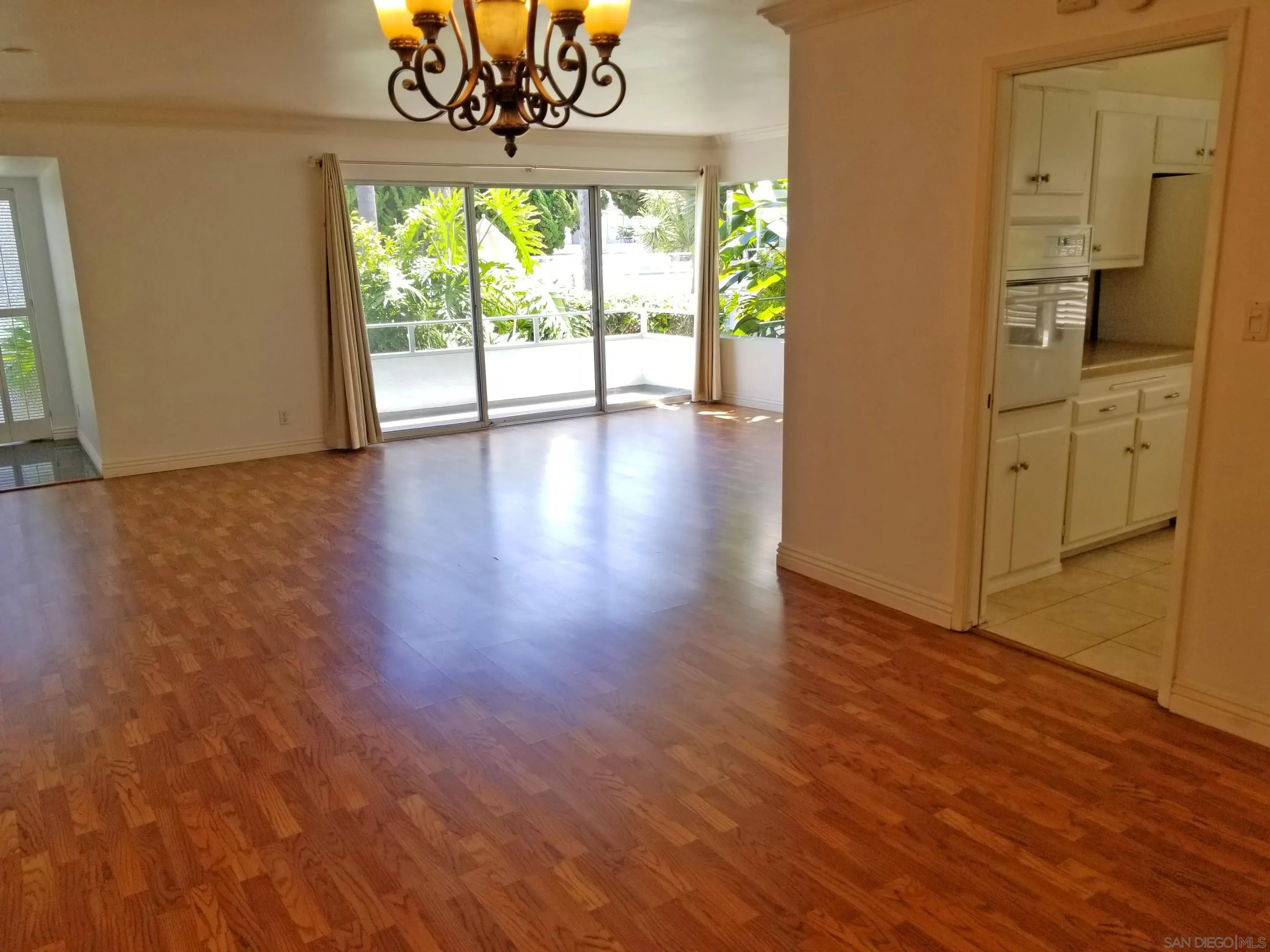 2358 Torrey Pines Road, Unit 19 La Jolla, CA 92037 - Photo 6 of 28 a view of an empty room with a window and wooden floor
