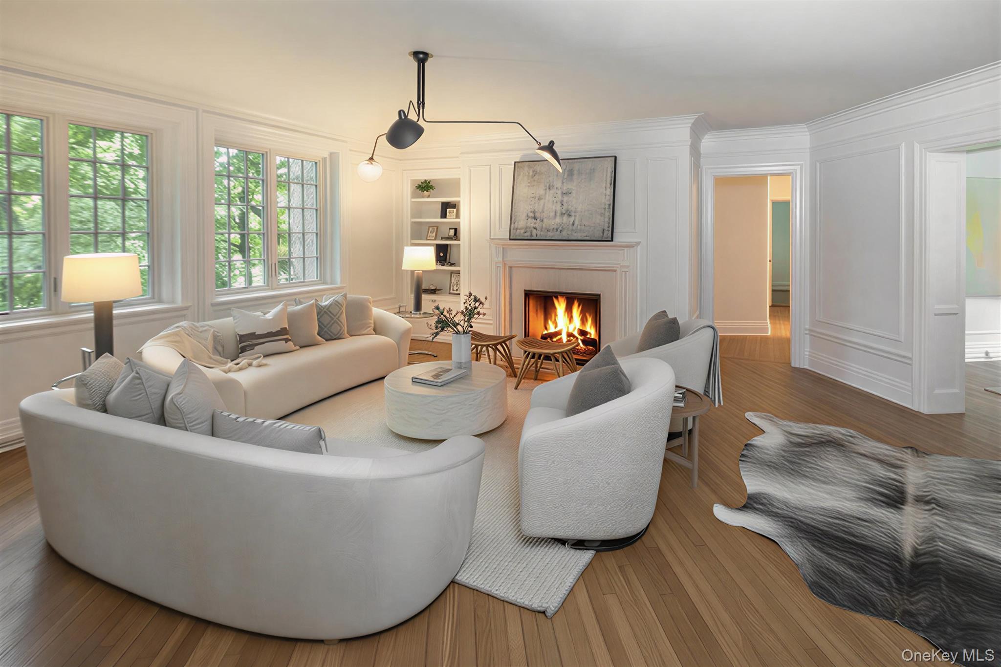 Spacious Living room with fireplace offers  lovely views of the Bronxville Lake through new divided light windows