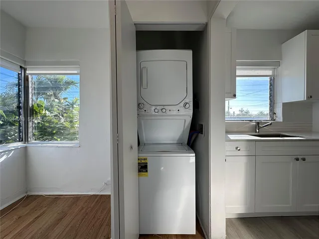 a view of a kitchen with a sink a fireplace and window