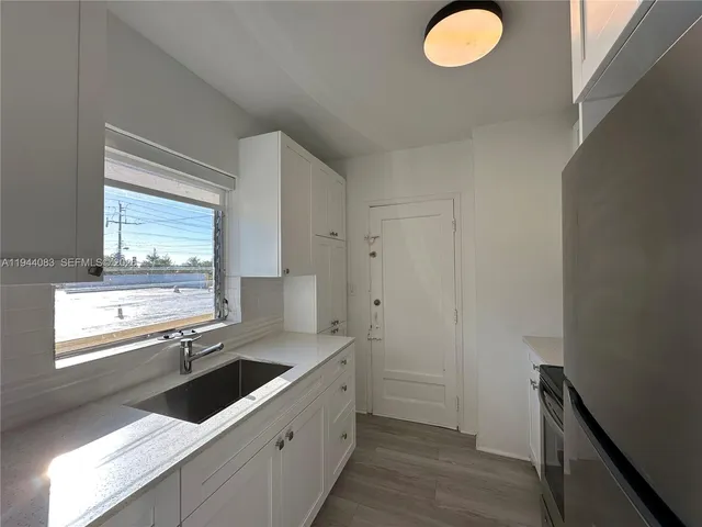 a kitchen with granite countertop a sink and a window