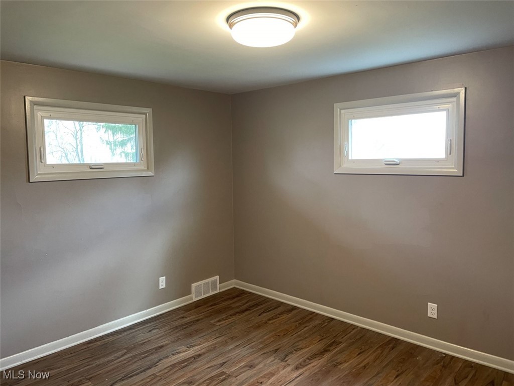 855 Georgetown Road Salem, OH 44460 - Photo 12 of 28 Spare room with dark wood-type flooring, visible vents, and baseboards