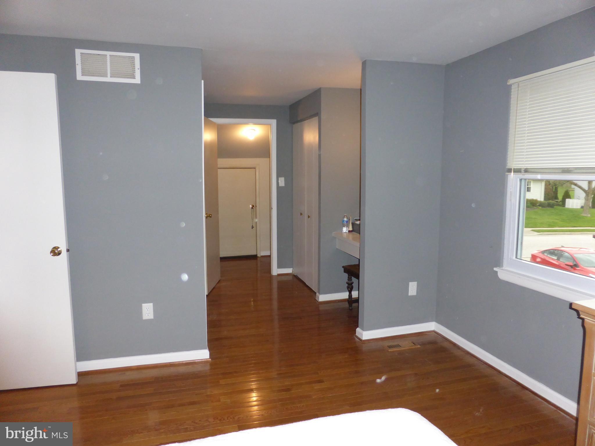9107 Bowline Road Baltimore, MD 21236 - Photo 11 of 19 a view of a hallway with wooden floor and a room