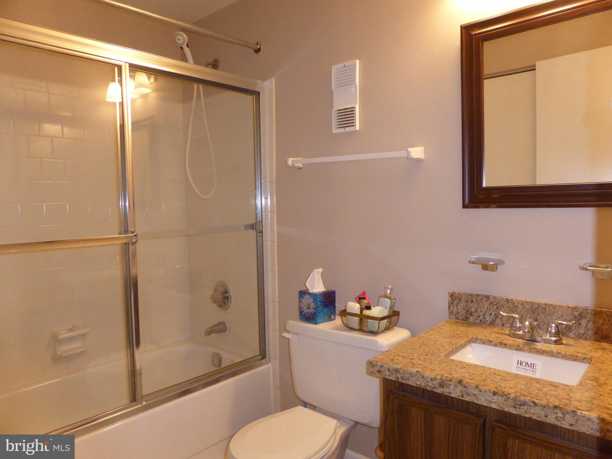9107 Bowline Road Baltimore, MD 21236 - Photo 13 of 19 a bathroom with a granite countertop sink toilet and shower