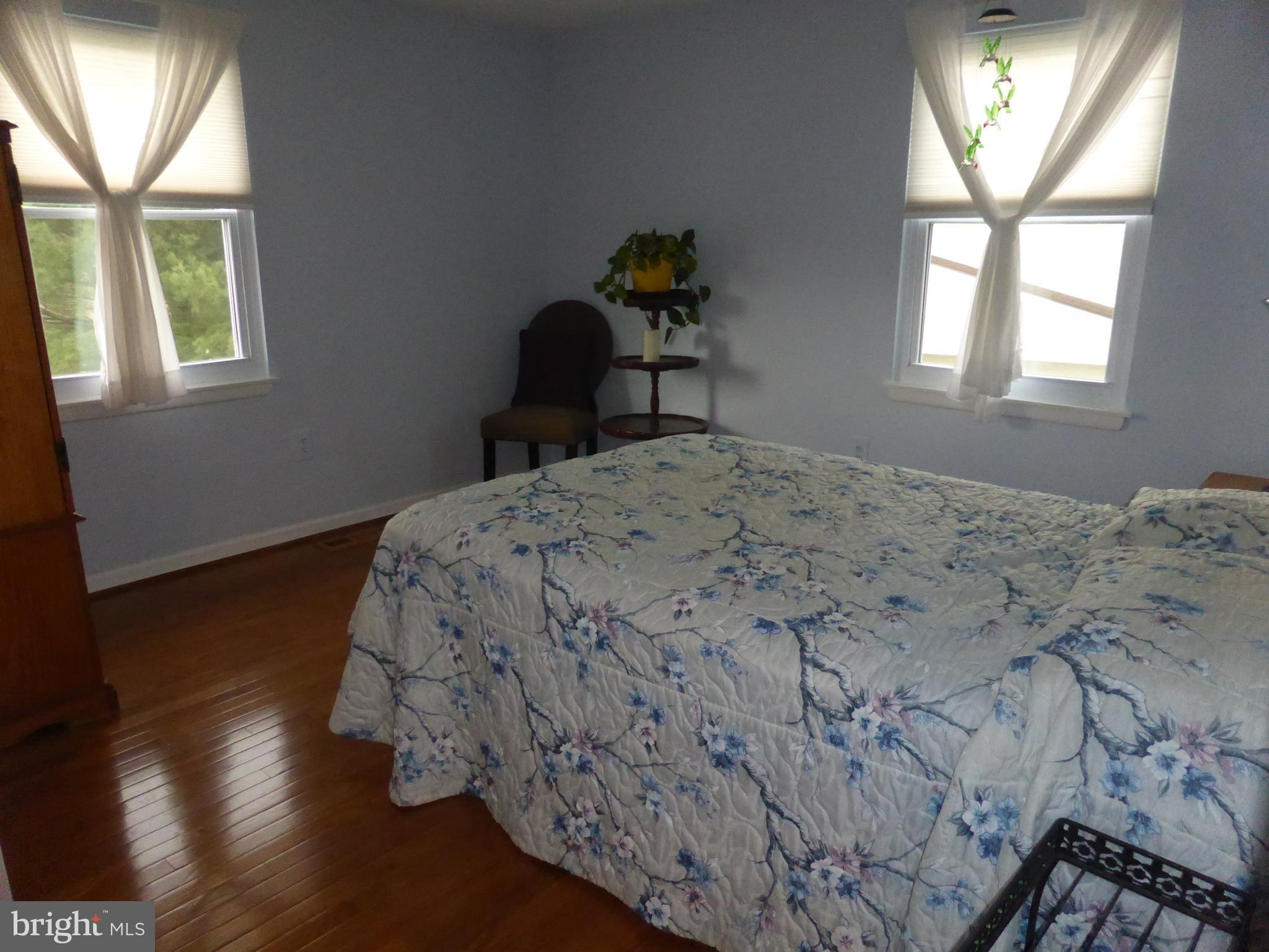 9107 Bowline Road Baltimore, MD 21236 - Photo 14 of 19 a bedroom with a bed and wooden floor
