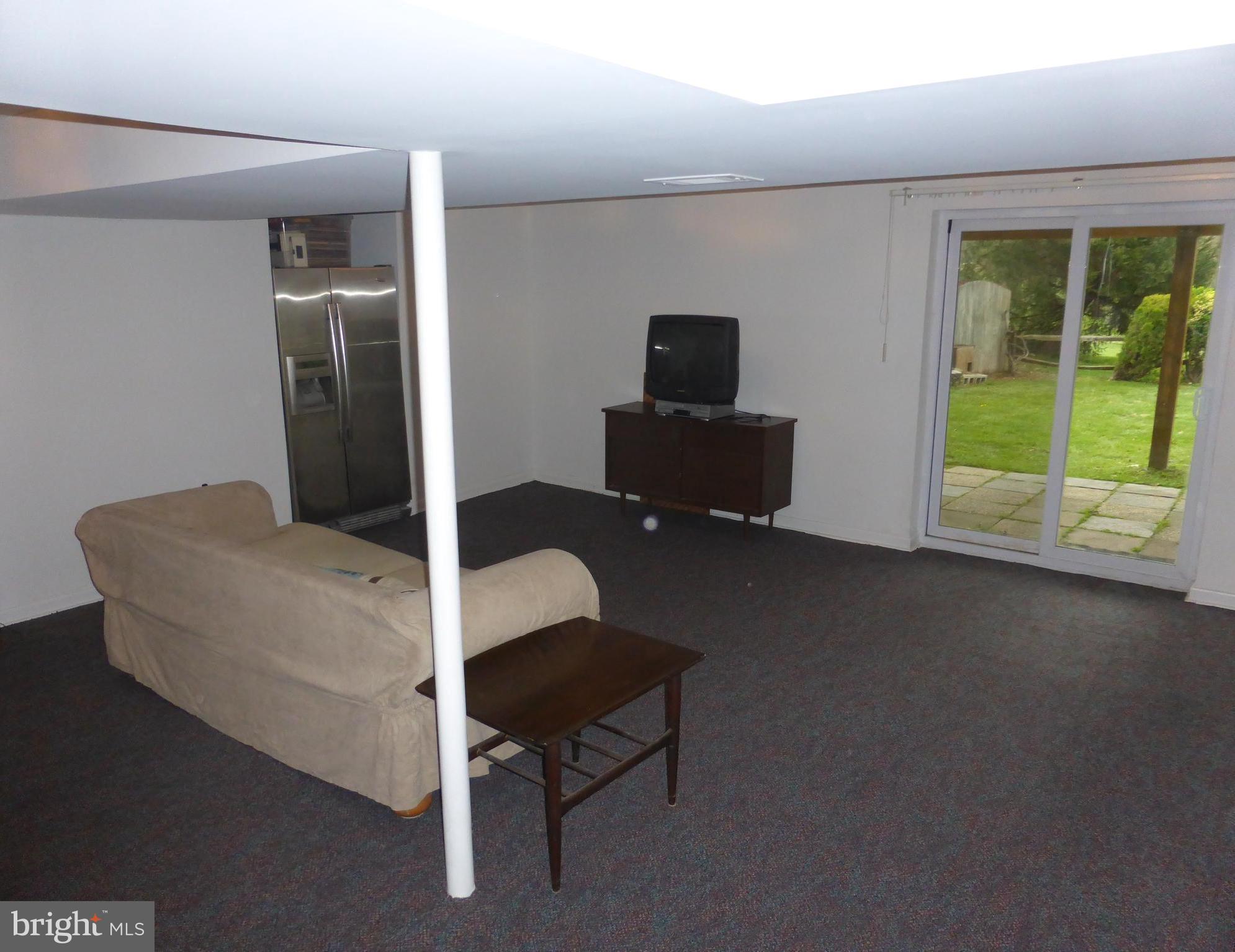 9107 Bowline Road Baltimore, MD 21236 - Photo 15 of 19 a living room with furniture and a flat screen tv