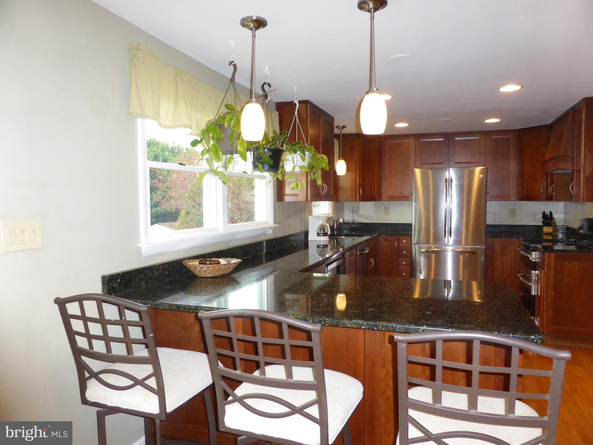 9107 Bowline Road Baltimore, MD 21236 - Photo 6 of 19 a kitchen with stainless steel appliances granite countertop a sink a stove and a wooden floors