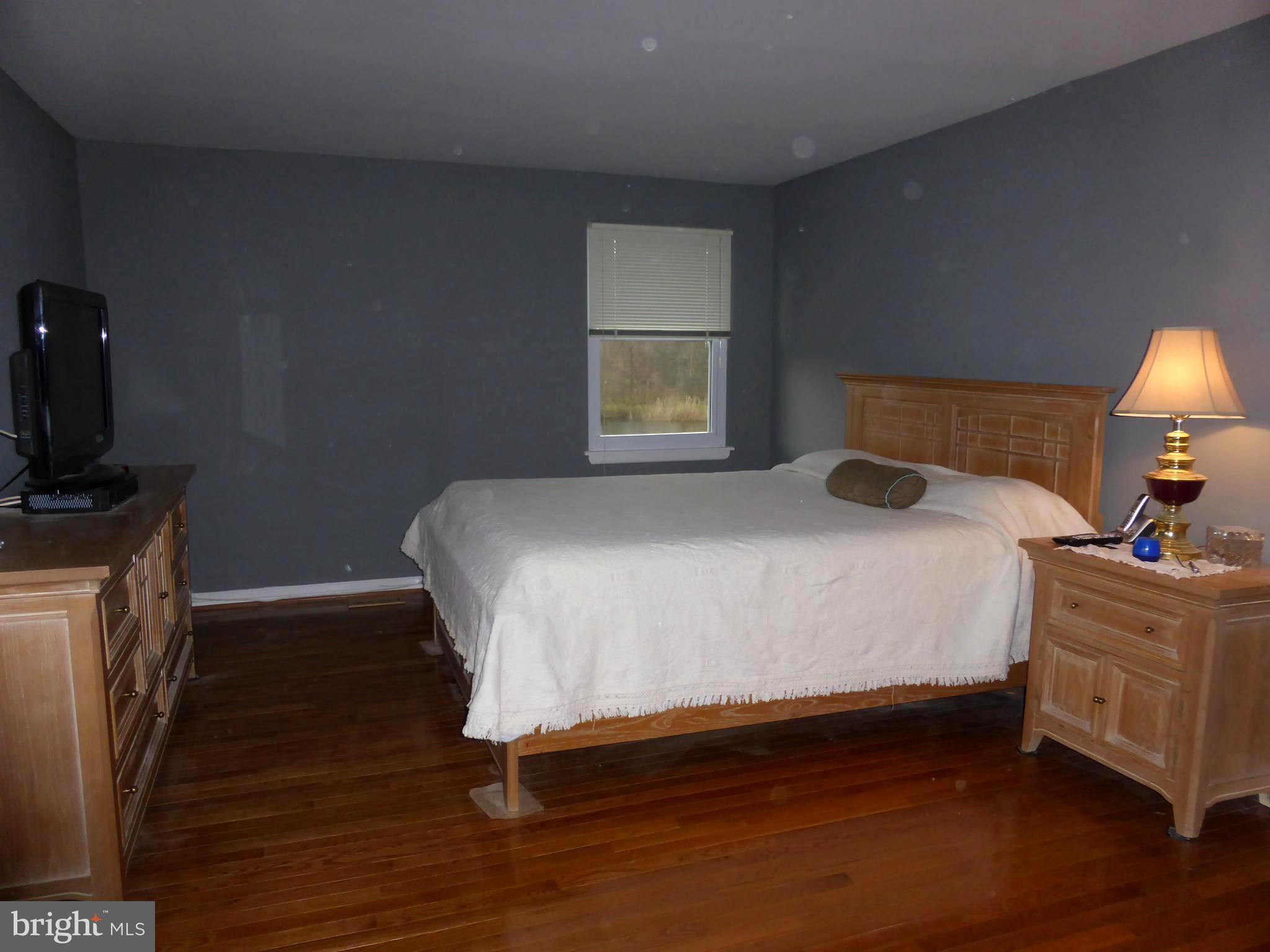 9107 Bowline Road Baltimore, MD 21236 - Photo 9 of 19 a bedroom with a bed and a tv on the dresser